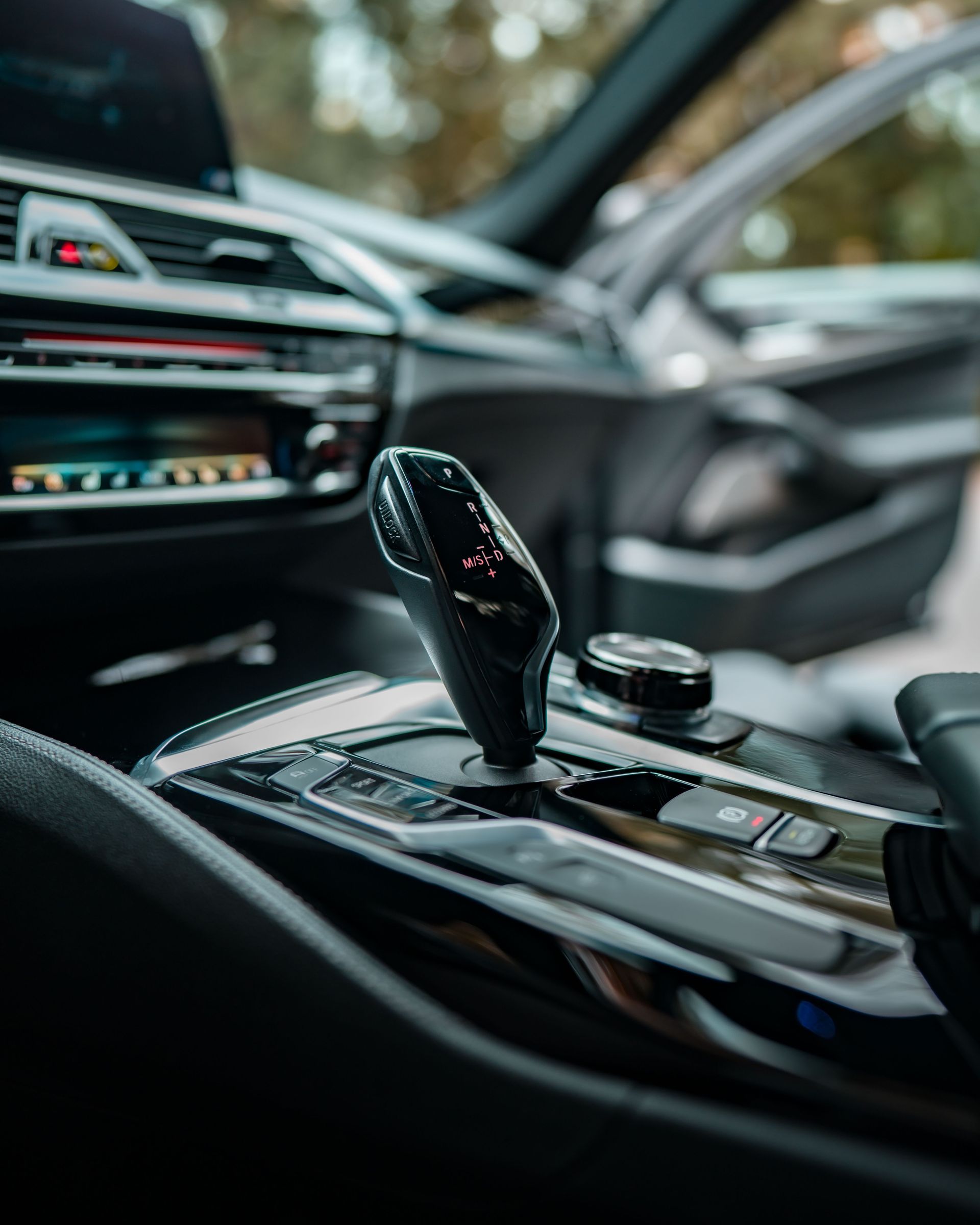 Up-close view of a luxury car's advanced interior highlighting the gear shift.